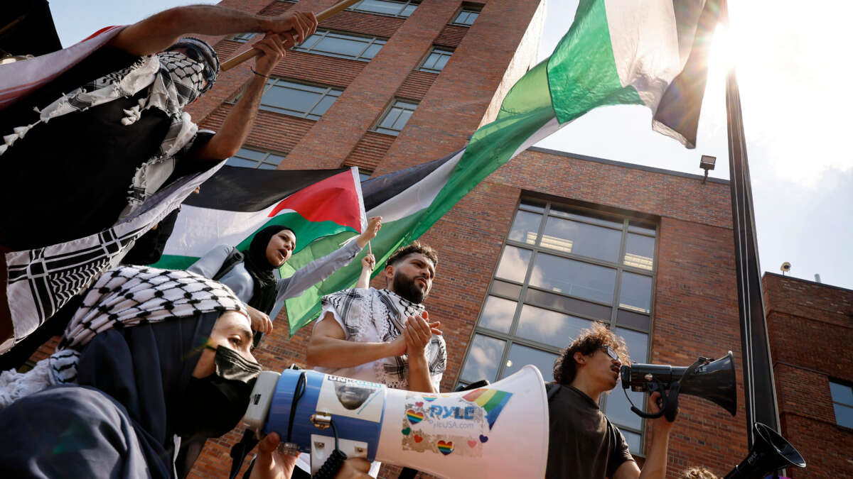 Pro-Palestinian demonstrators celebrate after raising the Palestinian flag outside Lisner Hall as they rally on the campus of George Washington University on May 2, 2024, in Washington, D.C.