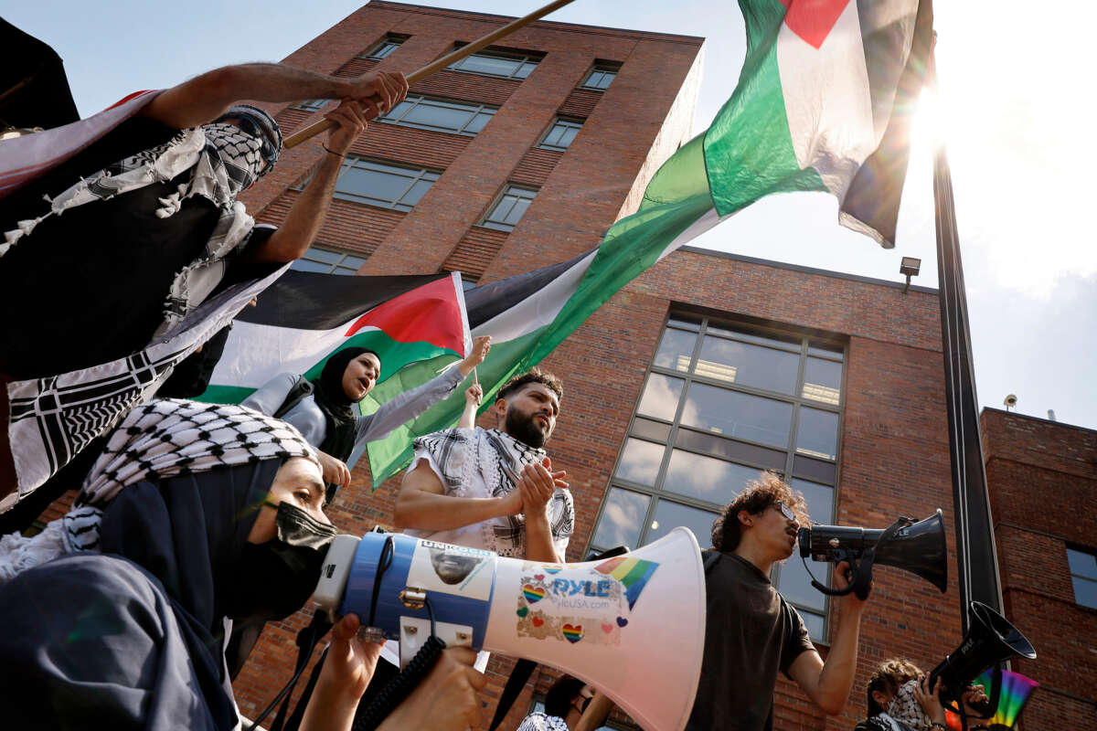 Pro-Palestinian demonstrators celebrate after raising the Palestinian flag outside Lisner Hall as they rally on the campus of George Washington University on May 2, 2024, in Washington, D.C.