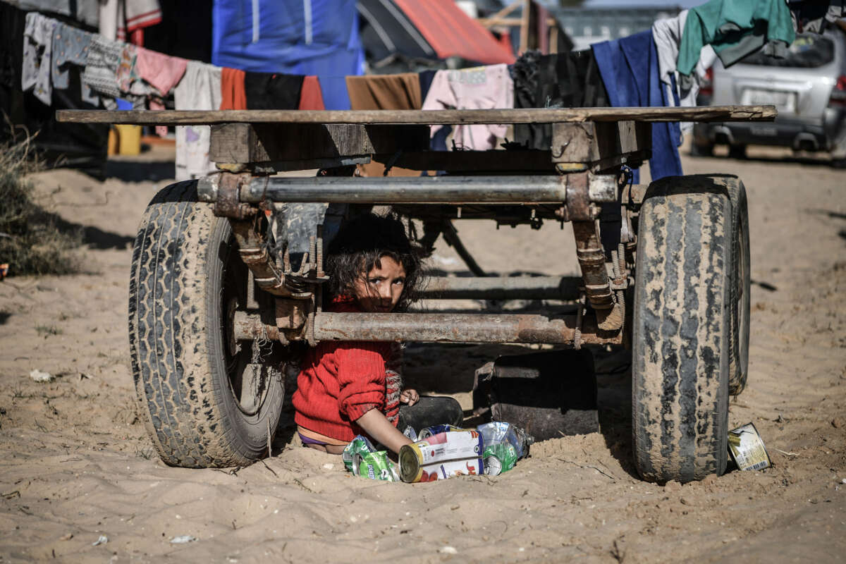 Members of a Palestinian family with children are seen around the truck they live in, which has been abandoned since fuel is not easily available as Israeli attacks continue in Rafah, Gaza, on January 22, 2024.