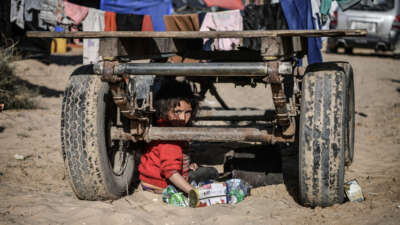 Members of a Palestinian family with children are seen around the truck they live in, which has been abandoned since fuel is not easily available as Israeli attacks continue in Rafah, Gaza, on January 22, 2024.