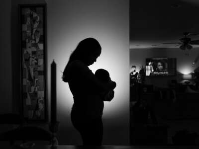 A mother holds her baby, who was born in December of 2022, at their home on February 2, 2023, in Houston, Texas.