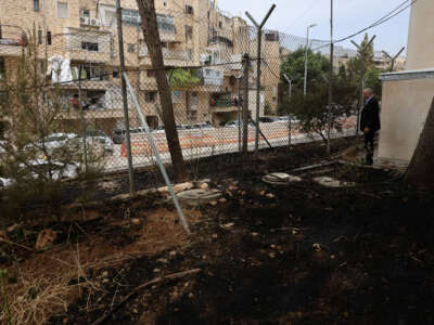 United Nations Relief and Works Agency for Palestine Refugees (UNRWA) Affairs Director in the West Bank Adam Bouloukos visits the agency's headquarters in east Jerusalem, where the traces of a fire are visible after Israeli extremists reportedly set ablaze the perimeter of the building on May 10, 2024.