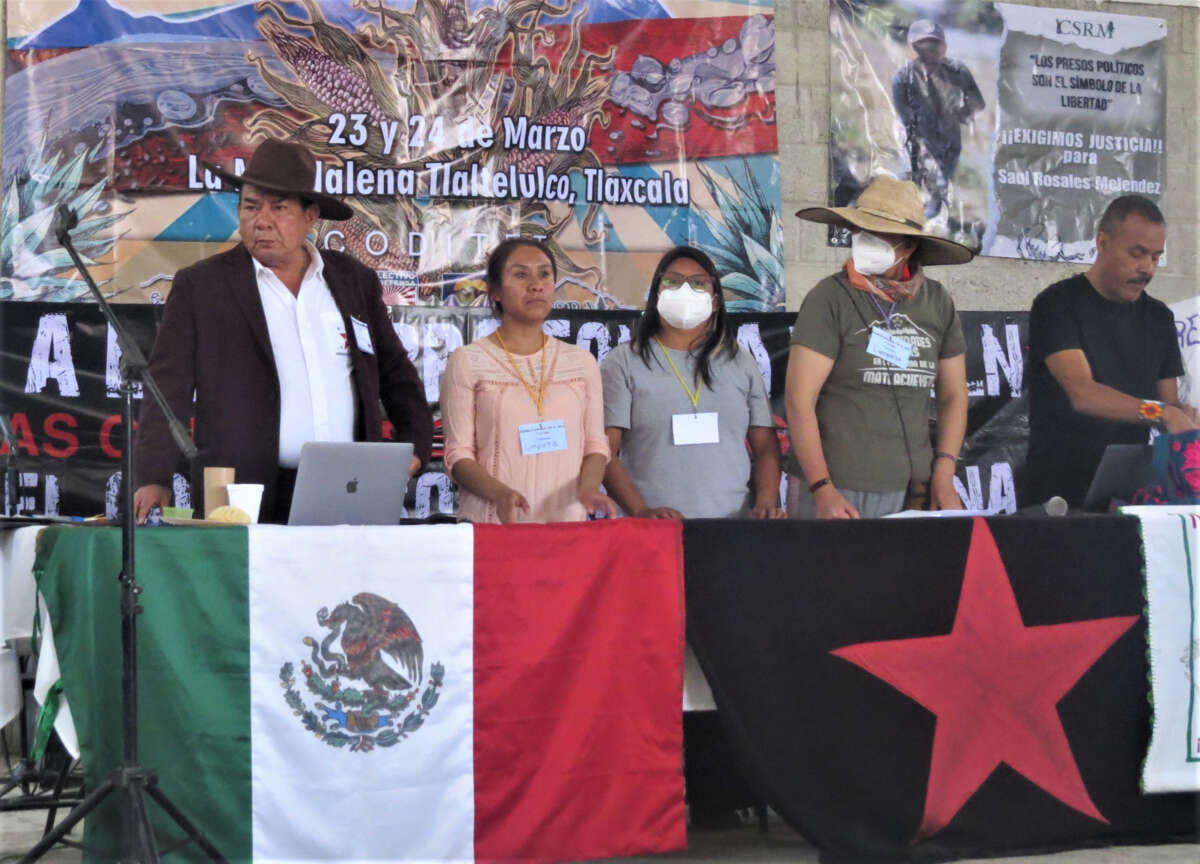 Tlaxcala activists speak out against real estate and other corporate and institutional attacks on their land. In the background, right, is a banner demanding Nahuatl community leader and land defender, Saúl Rosales, be freed.