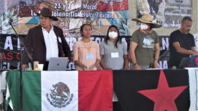 Tlaxcala activists speak out against real estate and other corporate and institutional attacks on their land. In the background, right, is a banner demanding Nahuatl community leader and land defender, Saúl Rosales, be freed.