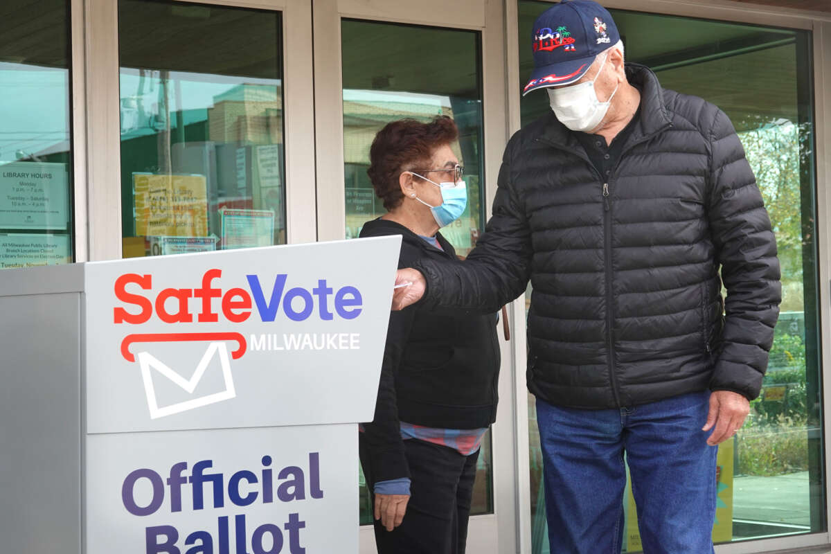 Residents drop mail-in ballots in an official ballot box outside of the Tippecanoe branch library on October 20, 2020, in Milwaukee, Wisconsin.