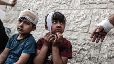 Two wounded children are seen with bandages on their heads after being brought to the Shuhada al-Aqsa Hospital and treated following an Israeli attack hit the Maghazi Camp area in Deir Al Balah, Gaza, on May 11, 2024.