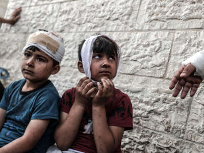 Two wounded children are seen with bandages on their heads after being brought to the Shuhada al-Aqsa Hospital and treated following an Israeli attack hit the Maghazi Camp area in Deir Al Balah, Gaza, on May 11, 2024.