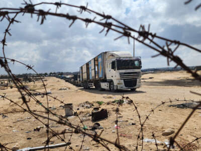 Palestinian truck drivers and United Nations vehicles wait near the Rafah border gate on the Gazan side to cross the Egyptian side after the Israeli army took control of the Rafah Border Gate and announced that it would close all entrances and exits, including the entrance of aid supplies, during the Israeli operations in Rafah, Gaza, on May 14, 2024.