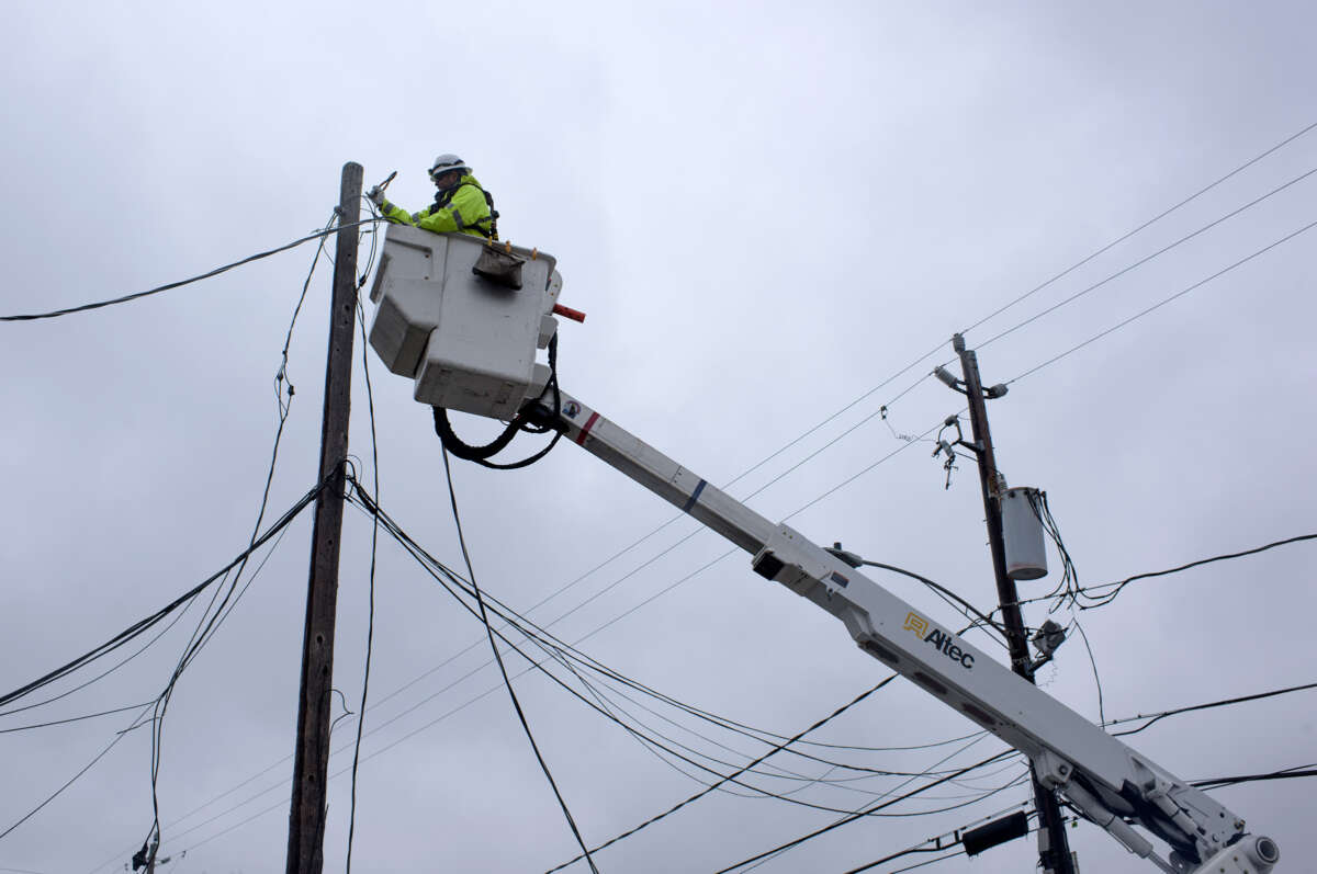 An electrical worker maintains power lines