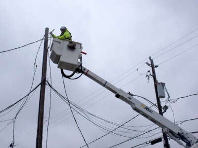 An electrical worker maintains power lines