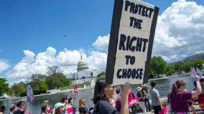 A demonstrator holds a sign reading "Protect the right to choose" during a march at the U.S. Capitol on April 15, 2023, in Washington, D.C.