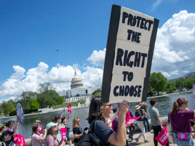 A demonstrator holds a sign reading "Protect the right to choose" during a march at the U.S. Capitol on April 15, 2023, in Washington, D.C.