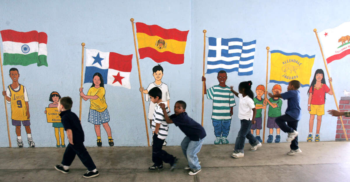 Schoolchildren walk back to class and play in front of a mural on December 12, 2005, in Pasadena, California.