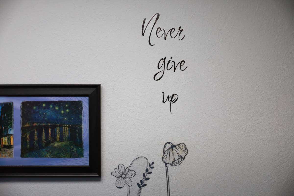 A wall decal displayed at an abortion clinic reads "Never give up"