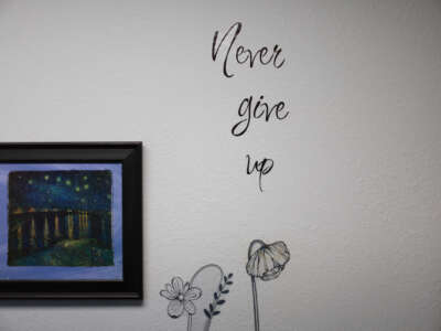 A wall decal displayed at an abortion clinic reads "Never give up"