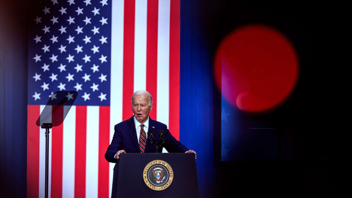 Joe Biden speaks at a podium in front of a U.S. flag