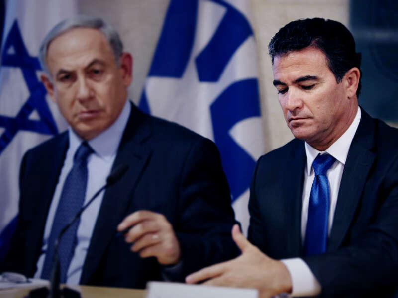 Prime Minister Benjamin Netanyahu sits next to Yossi Cohen