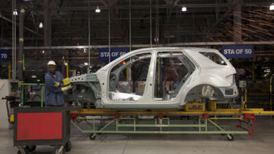 Mercedes employees work on assembly line