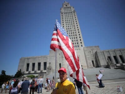 Protesters gather outside the Louisiana state capitol during a rally against Louisiana's stay-at-home order and economic shutdown on April 25, 2020, in Baton Rouge, Louisiana.