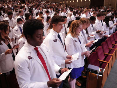 Medical students recite an oath they wrote together during the University of Minnesota Medical Schools annual White Coat Ceremony for the class of 2026 on August 19, 2022, in Minneapolis, Minnesota.