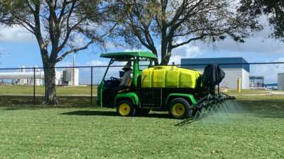 Landscapers spraying pesticides in Florida.