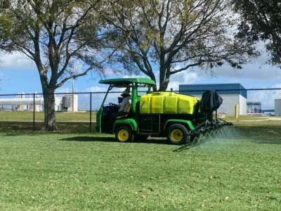 Landscapers spraying pesticides in Florida.
