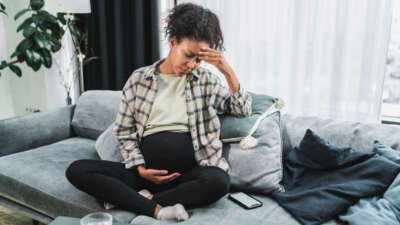 Black pregnant woman feeling tired and exhausted.
