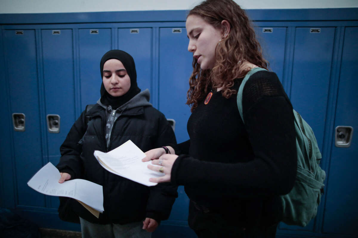 Rawda Elbatrawish (L) and Liora Pelavin organize flyers for a student dialogue at Teaneck High School in Teaneck, New Jersey, on January 19, 2024.
