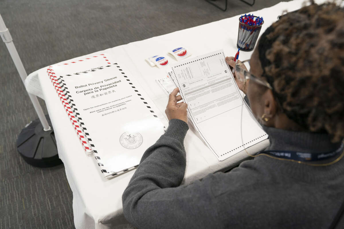 A New York City poll worker examines blank ballots on April 1, 2024.