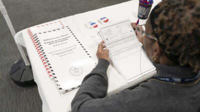 A New York City poll worker examines blank ballots on April 1, 2024.