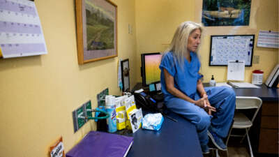 Dr. Barbara Zipkin of Sherman Oaks contemplates while sitting on a counter top at Camelback Family Planning on April 18, 2024, in Phoenix, Arizona.