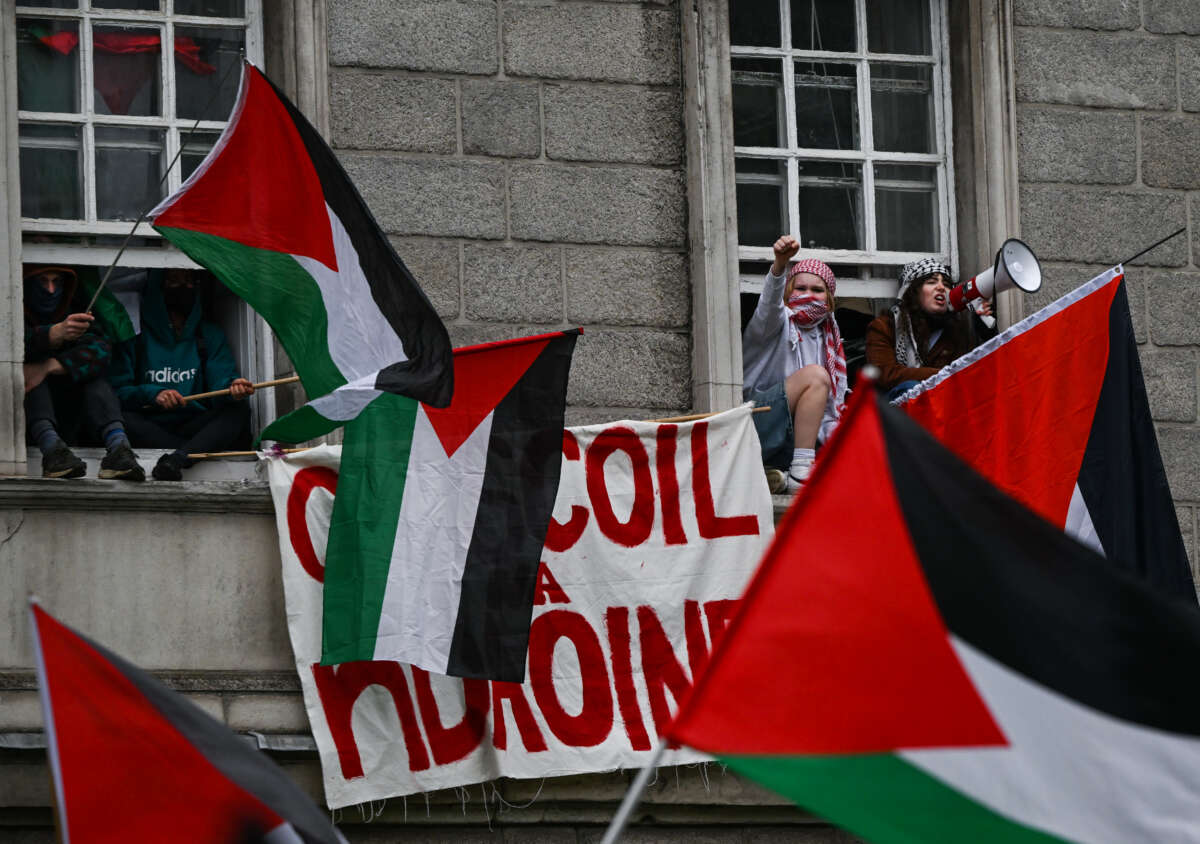 Pro-Palestine activists wave Palestinian flags at Trinity College
