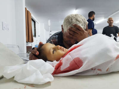 A Palestinian man mourns his grandson, killed in an Israeli strike on a camp for displaced Gazans, at a hospital in Rafah on May 26, 2024.