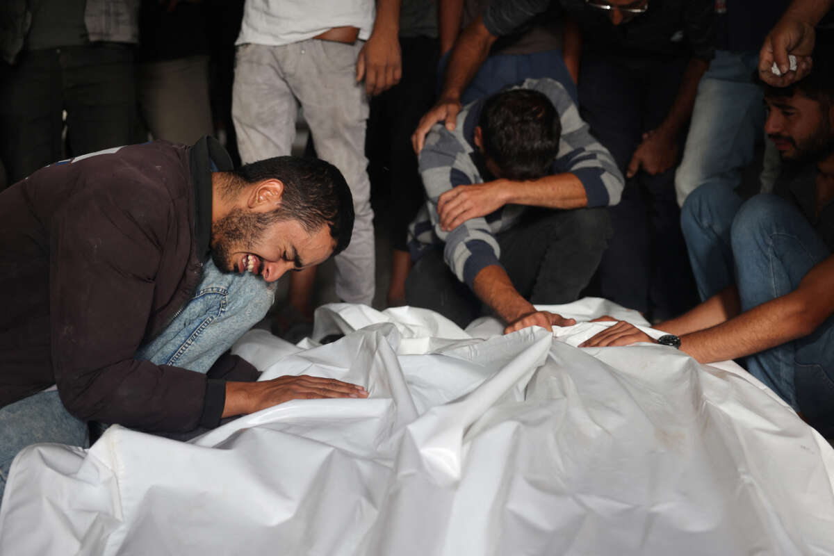Palestinians in Gaza mourn relatives killed in an overnight Israeli strike on a camp for internally displaced people in Rafah on May 27, 2024.