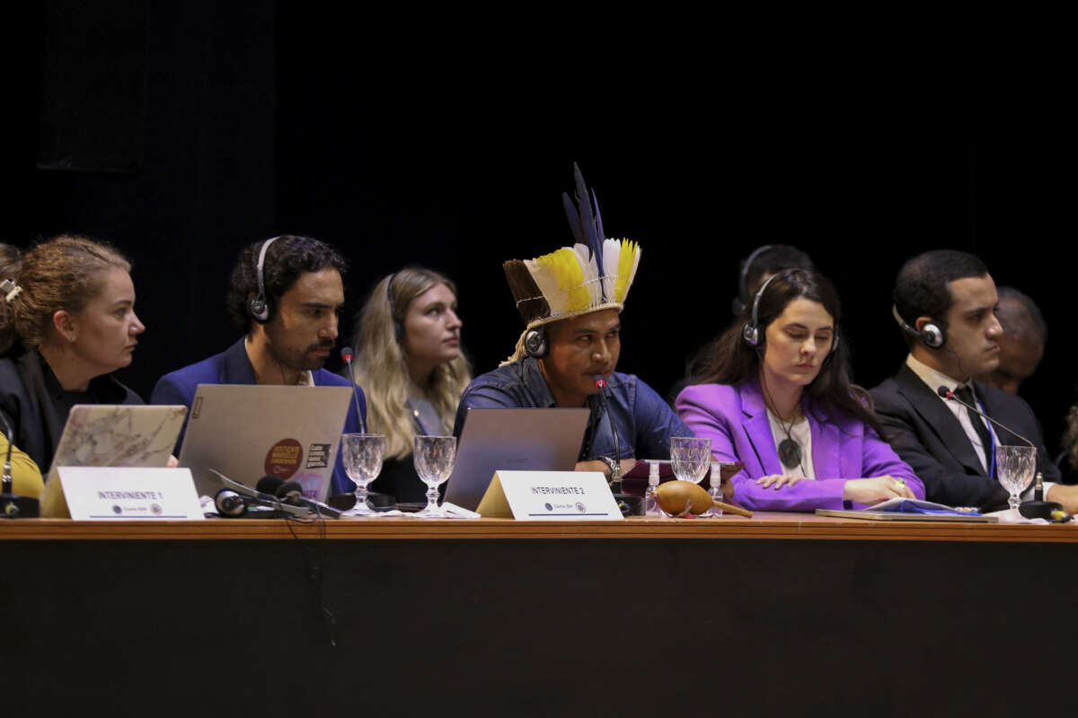 A member of the Guarani-Kaiowa ethnic group (center) attends a hearing on the responsibility of states in the face of climate emergencies, organized by the Inter-American Court of Human Rights, in Manaus, Brazil, on May 27, 2024.