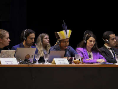 A member of the Guarani-Kaiowa ethnic group (center) attends a hearing on the responsibility of states in the face of climate emergencies, organized by the Inter-American Court of Human Rights, in Manaus, Brazil, on May 27, 2024.