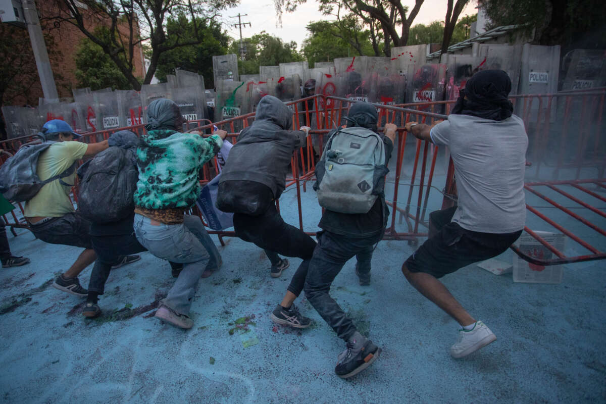 Protesters try to remove police barriers during a pro-Palestinian demonstration in front of Israel's Embassy to Mexico on May 28, 2024, in Mexico City, Mexico.