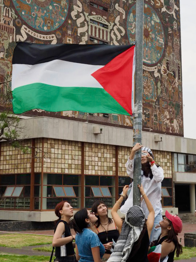 Activists praise a Palestinian flag at a camp protesting against Israel's attacks on the Gaza Strip, UNAM's Ciudad Universitaria campus in the south of Mexico City on May 2, 2024.