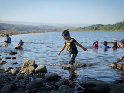 A boy and a girl step out of the Lempa River in El Salvador. The Lempa is the country’s largest river.