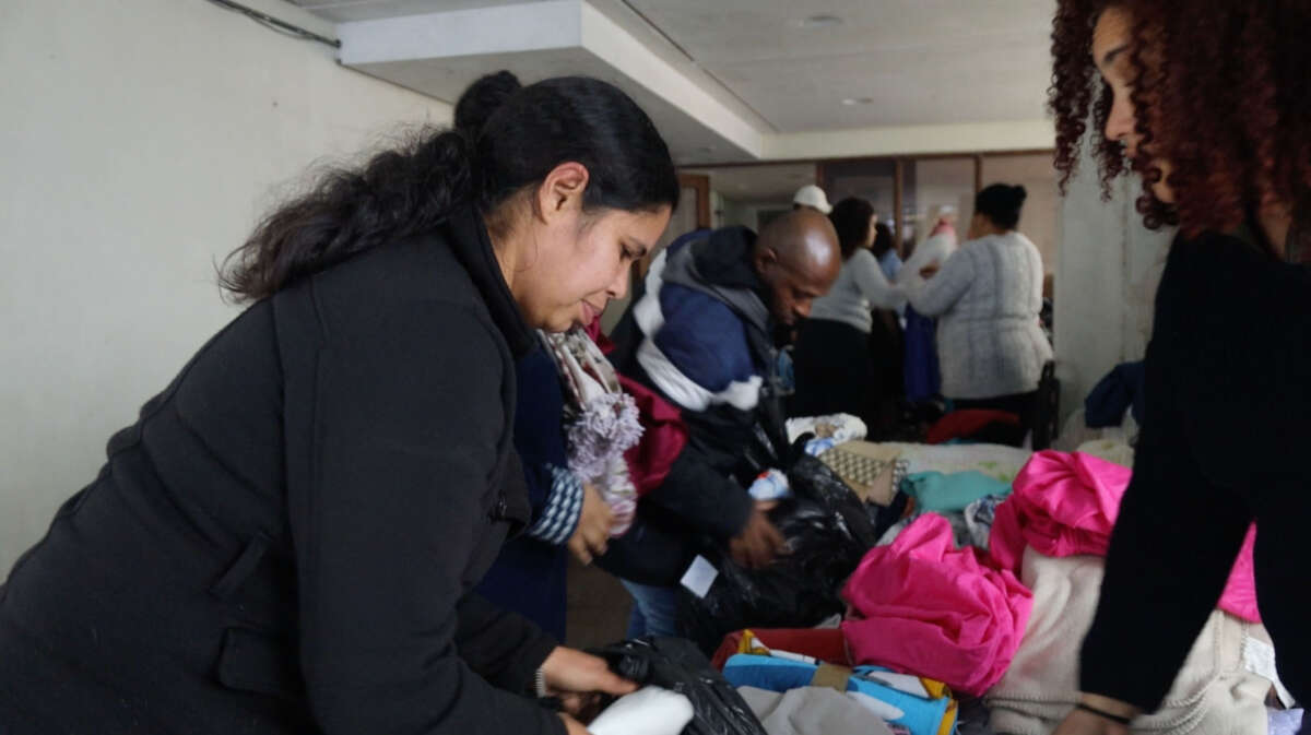 Liziane Pacheco Dutra looks through recently arrived donations at the occupation in late May.