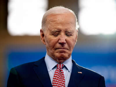 President Joe Biden stands on stage as Vice President Kamala Harris introduces him during a campaign rally at Girard College on May 29, 2024, in Philadelphia, Pennsylvania.