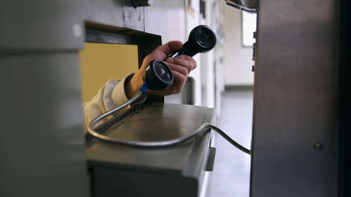 An immigrant makes a call from his 'segregation cell' at the Adelanto Detention Facility on November 15, 2013, in Adelanto, California.