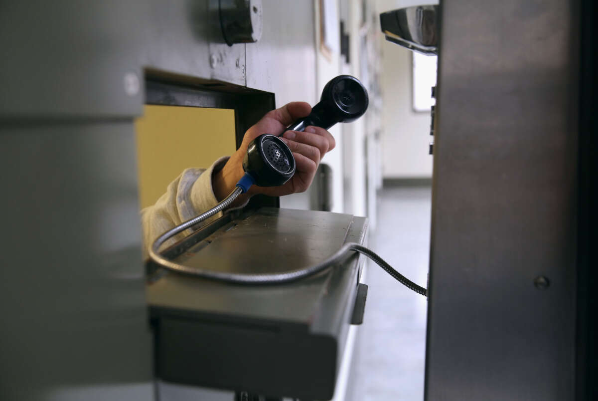 An immigrant makes a call from his 'segregation cell' at the Adelanto Detention Facility on November 15, 2013, in Adelanto, California.