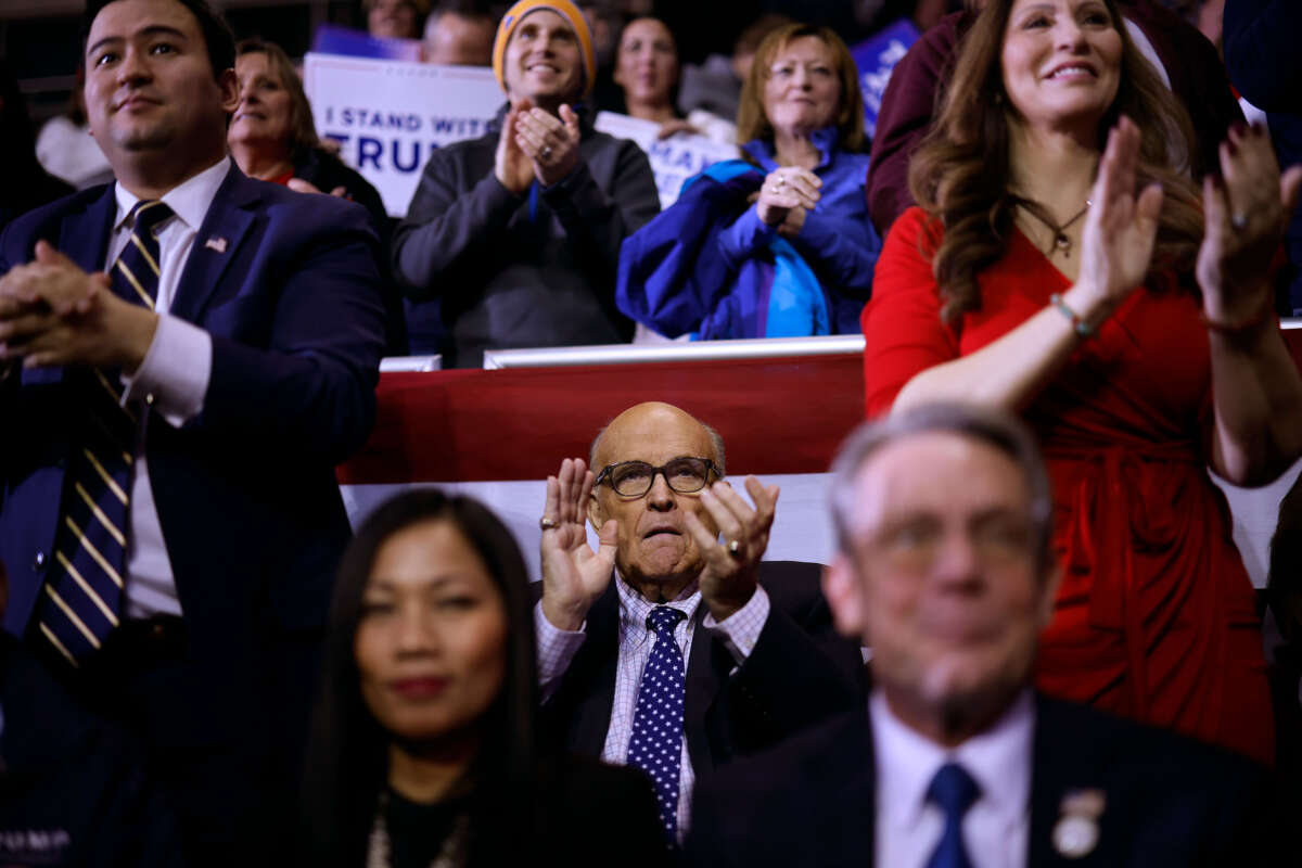 Rudy Giuliani (center) attends a campaign rally for Republican presidential candidate and former President Donald Trump at the SNHU Arena on January 20, 2024, in Manchester, New Hampshire.