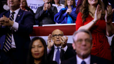 Rudy Giuliani (center) attends a campaign rally for Republican presidential candidate and former President Donald Trump at the SNHU Arena on January 20, 2024, in Manchester, New Hampshire.
