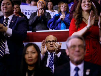 Rudy Giuliani (center) attends a campaign rally for Republican presidential candidate and former President Donald Trump at the SNHU Arena on January 20, 2024, in Manchester, New Hampshire.
