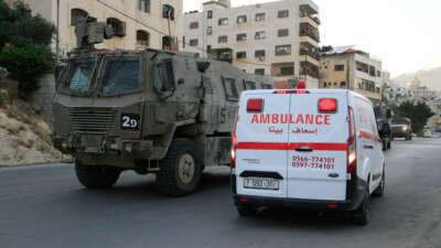 Palestinian ambulances are parked as clashes take place between Palestinian protesters and Israeli troops during a raid on the Balata refugee camp on June 3, 2024.