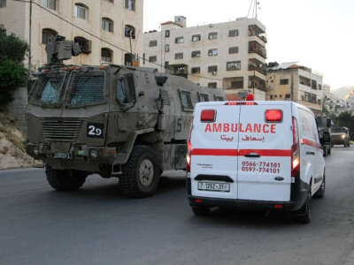 Palestinian ambulances are parked as clashes take place between Palestinian protesters and Israeli troops during a raid on the Balata refugee camp on June 3, 2024.