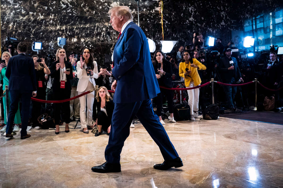 Donald Trump walks past reporters