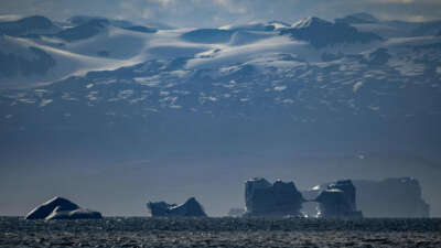 Melting icebergs drift off near a glacier in Scoresby Sound, Greenland, on August 16, 2023.